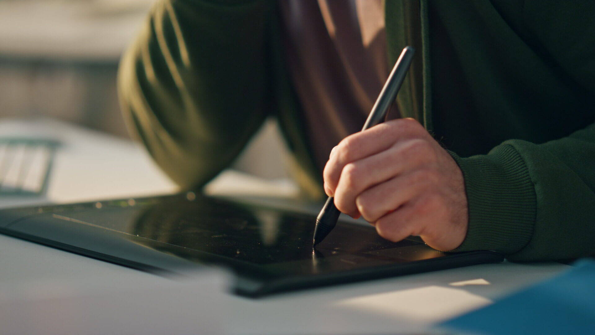 adult-drawing-on-a-tablet-at-a-table-2026-03-11-01-01-55-utc.jpg
