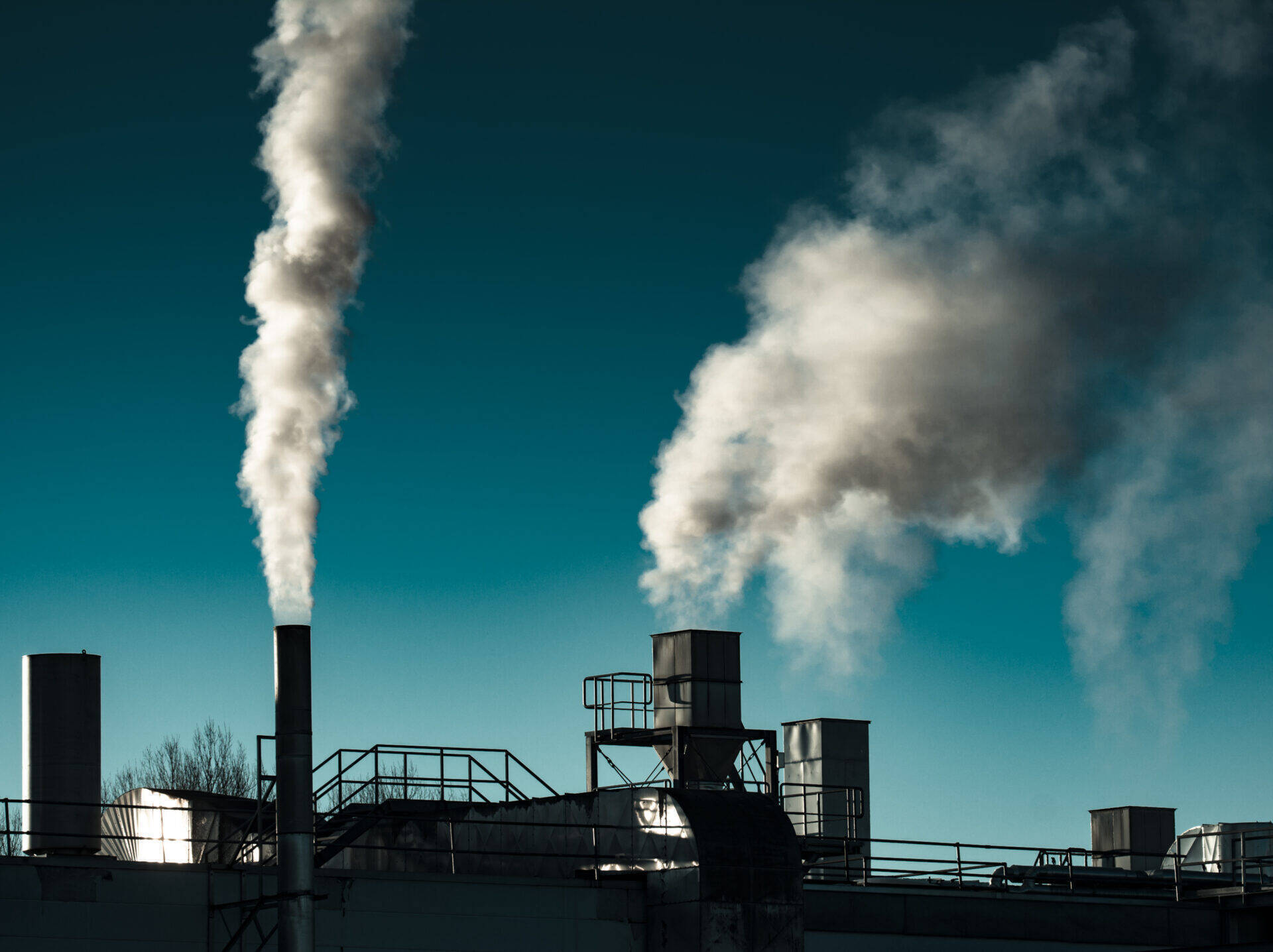 industrial-chimneys-emitting-smoke-against-a-clear-2026-03-17-06-30-21-utc-2.jpg